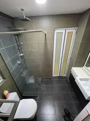 a bathroom with a shower and a toilet and a sink at Cozy studio family lake view SETAPAK CENTRAL MALL in Kuala Lumpur