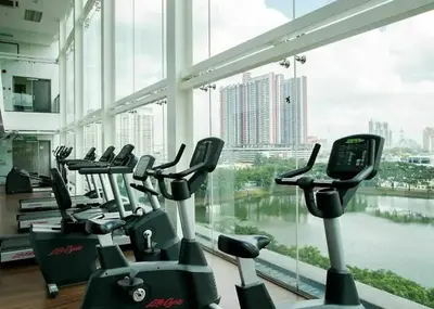 a row of cardio machines in a gym with a large window at Cozy studio family lake view SETAPAK CENTRAL MALL in Kuala Lumpur