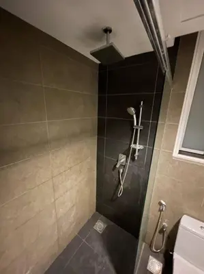 a bathroom with a shower stall with a toilet at Cozy lake view at top of setapak central mall in Kuala Lumpur