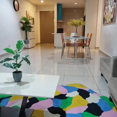 a living room with a table and chairs at Cozy lake view at top of setapak central mall in Kuala Lumpur
