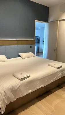 a large bed with two towels on it in a room at STAR RESIDENCE KLCC By GANTYA in Kuala Lumpur