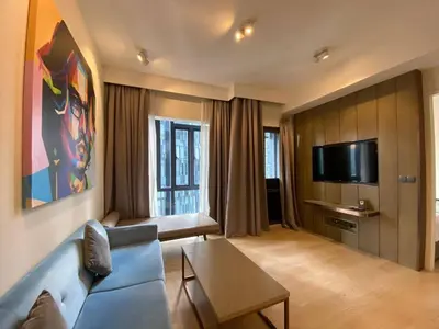 a living room with a blue couch and a tv at STAR RESIDENCE KLCC By GANTYA in Kuala Lumpur