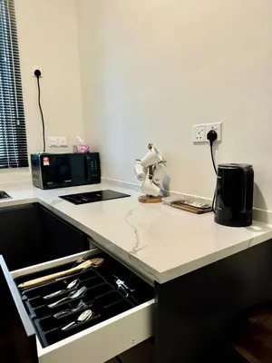 a kitchen with a counter top with a stove top oven at RSJ Homestay at Setapak - Studio in Kuala Lumpur