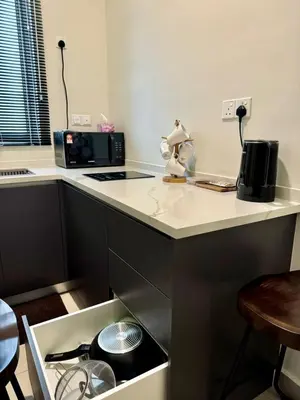 a kitchen with a counter with a stove and a microwave at RSJ Homestay at Setapak - Studio in Kuala Lumpur