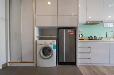 a kitchen with a refrigerator and a washing machine at Sky Manor One Bukit Ceylon KLCC in Kuala Lumpur