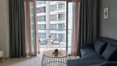 a living room with a couch and a table in front of a window at Hostel At Regalia Residence in Kuala Lumpur
