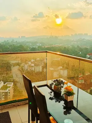 a table and chairs on a balcony with a view at Casablanca Skypool Hostel in Kuala Lumpur