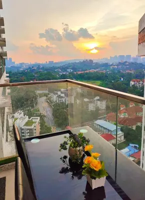 a balcony with a table with flowers on it at Casablanca Skypool Hostel in Kuala Lumpur