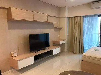 a living room with a flat screen tv on a wall at Bmchomes Mercu summer suite in Kuala Lumpur