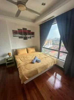 a bedroom with a bed with a large window at Golden HeavenHomestay in Kuala Lumpur