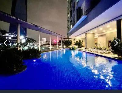 a large blue swimming pool in a building at Golden HeavenHomestay in Kuala Lumpur