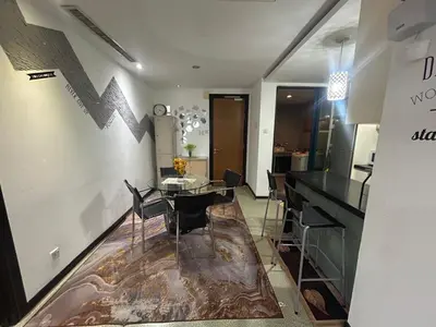 a dining room with a table and some chairs at Golden HeavenHomestay in Kuala Lumpur