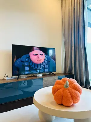 a living room with a tv and a pumpkin on a table at V Residence Suites-3A in Kuala Lumpur