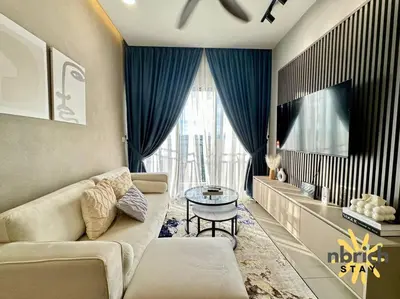 a living room with a couch and a table at Cozy Retreat in the heart of KL by nbrichstay in Kuala Lumpur