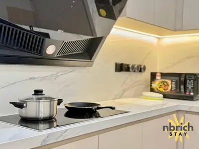 a pot on top of a stove in a kitchen at Cozy Retreat in the heart of KL by nbrichstay in Kuala Lumpur