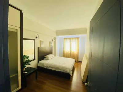 a small bedroom with a bed and a mirror at Luxury Room Minutes from KLCC in Kuala Lumpur