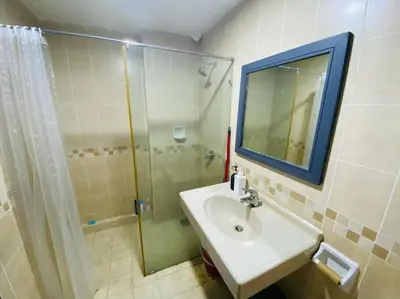 a bathroom with a sink and a shower with a mirror at Luxury Room Minutes from KLCC in Kuala Lumpur
