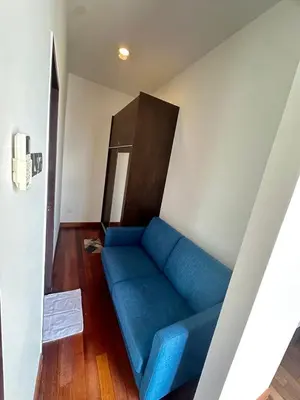 a living room with a blue couch in a room at Tamu Hotel & Suites Stay in Kuala Lumpur