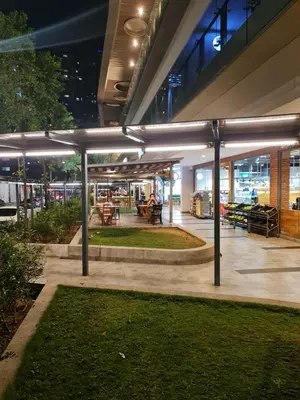 a building with a courtyard with tables and benches at The Robertson Residence Kuala Lumpur in Kuala Lumpur