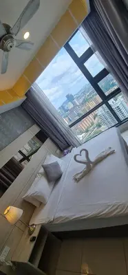 a room with a bed with a large window at The Robertson Residence Kuala Lumpur in Kuala Lumpur