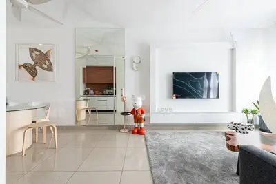a living room with a teddy bear standing in a room at M Vertica Kuala Lumpur by HLG Re in Kuala Lumpur