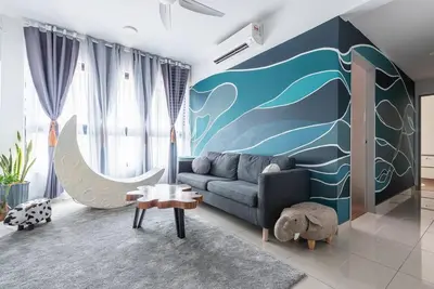a living room with a couch and a wave mural at M Vertica Kuala Lumpur by HLG Re in Kuala Lumpur
