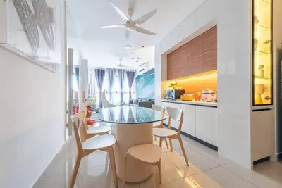 a dining room and kitchen with a glass table and chairs at M Vertica Kuala Lumpur by HLG Re in Kuala Lumpur