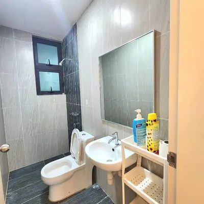a bathroom with a toilet and a sink and a mirror at Skyhomes KLCC New in Kuala Lumpur