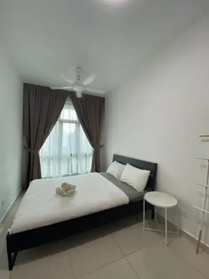 a bedroom with a bed with a teddy bear on it at Skyhomes KLCC New in Kuala Lumpur