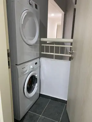 a laundry room with a washing machine and a washer at Skyhomes KLCC New in Kuala Lumpur