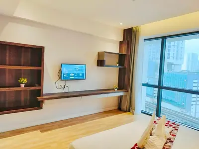 a living room with a tv and a large window at Lila Suites D, Majestic Place in Kuala Lumpur