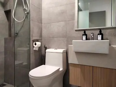 a bathroom with a toilet and a shower and a sink at Riveria Suites, KL Sentral by Homebrickz in Kuala Lumpur