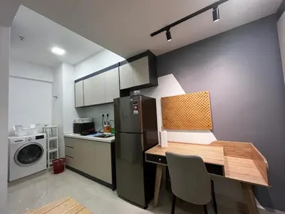 a small kitchen with a table and a refrigerator at THE COLONY INFINITUM Sweet Home SR in Kuala Lumpur