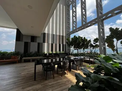 a restaurant with black tables and chairs and plants at THE COLONY INFINITUM Sweet Home SR in Kuala Lumpur