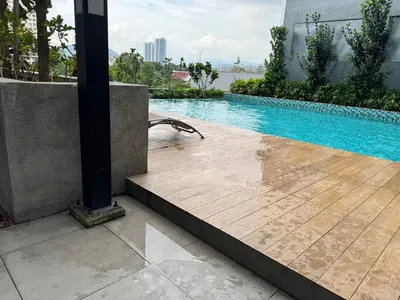 a swimming pool with a wooden deck next to a building at KL City Nue Suites Entire Condo 2R2B 3 plus 1 guests in Kuala Lumpur