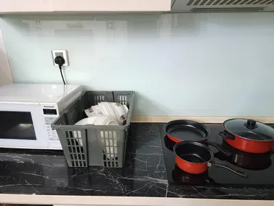 a kitchen counter with pots and pans and a microwave at 4R2B crest residences walk to klcc jln alor train 2station to bukitbintang water machine in Kuala Lumpur