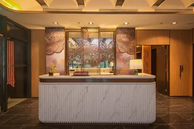 a bar in a hotel lobby with a painting on the wall at Imperial KLCC by Opus Hospitality in Kuala Lumpur