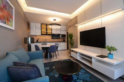 a living room with a couch and a flat screen tv at Imperial KLCC by Opus Hospitality in Kuala Lumpur