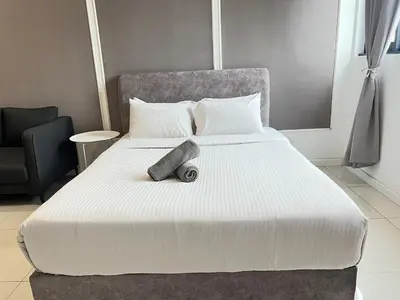 a large white bed in a room at Chambers Skylight Sernity Suites KLCC in Kuala Lumpur