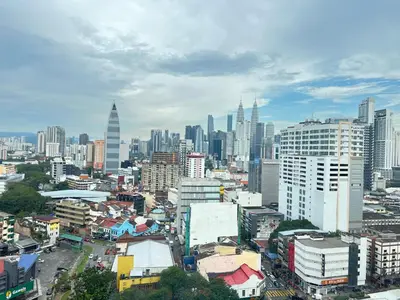 a city with skyscrapers and buildings in the background at Chambers Skylight Sernity Suites KLCC in Kuala Lumpur