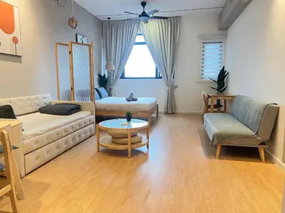 a living room with a couch and a table at Chambers Skylight Sernity Suites KLCC in Kuala Lumpur