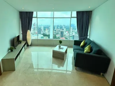 a living room with a couch and a large window at Vortex Apartments Kuala Lumpur in Kuala Lumpur