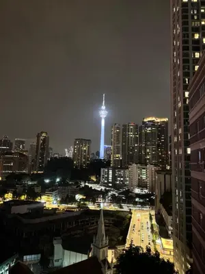 a city skyline at night with a lighted tower at Luxury Room At Bukit Bintang in Kuala Lumpur