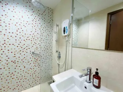 a bathroom with a sink and a shower at Regalia by sweet home in Kuala Lumpur