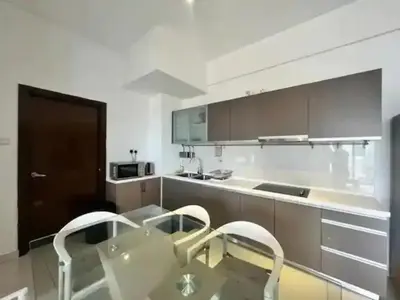 a kitchen with a glass table and two chairs at Regalia by sweet home in Kuala Lumpur