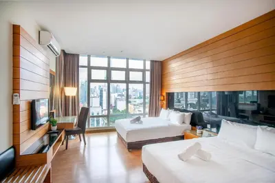 a hotel room with two beds and a large window at Dua Sentral 2km to KL Sentral in Kuala Lumpur