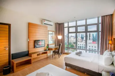 a hotel room with a bed and a desk and a television at Dua Sentral 2km to KL Sentral in Kuala Lumpur