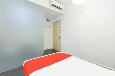 a white room with a red bench in it at Hotel O Pollodium Chinatown in Kuala Lumpur
