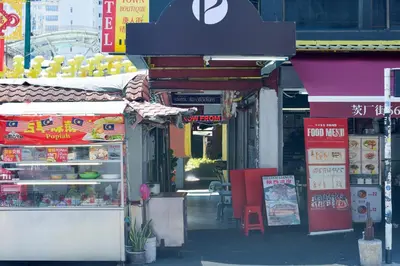 a food stand on a city street with food on display at Hotel O Pollodium Chinatown in Kuala Lumpur