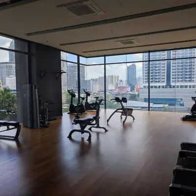 an empty room with chairs and a view of a city at Anggun residence studio klcc in Kuala Lumpur